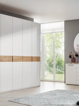 weißer Drehtürenschrank grifflos in hellem Schlafzimmer